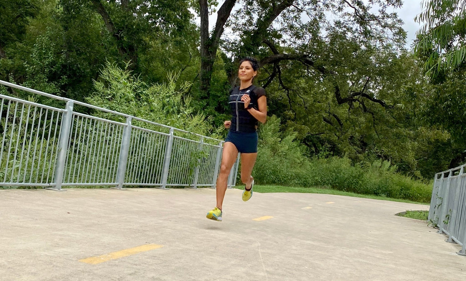 Picture of a person running with a weighted vest on a trail