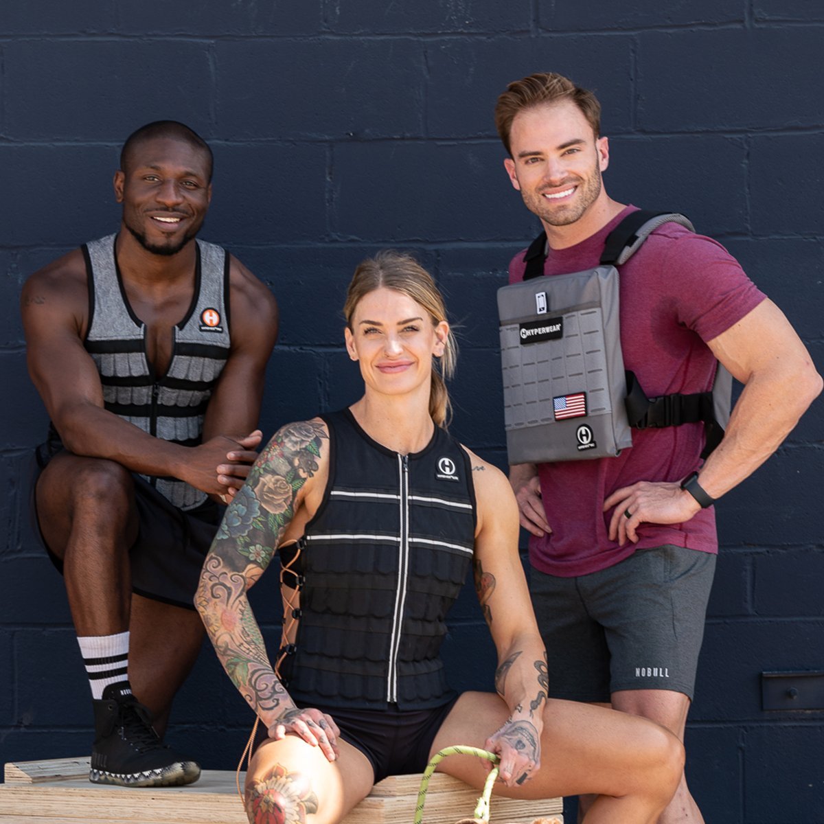 image of three fitness models wearing Hyper Vest weighted vests in a posed shot