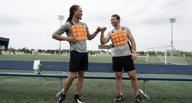 picture of two athlete models wearing Coolover cooling vest on a sideline on a field