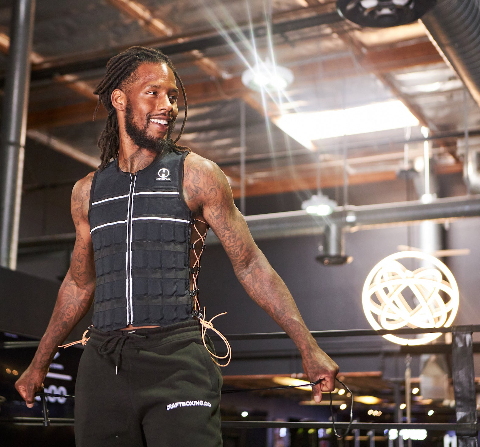 picture of an athlete jumping rope in a boxing gym wearing a Hyper Vest ELITE weight vest