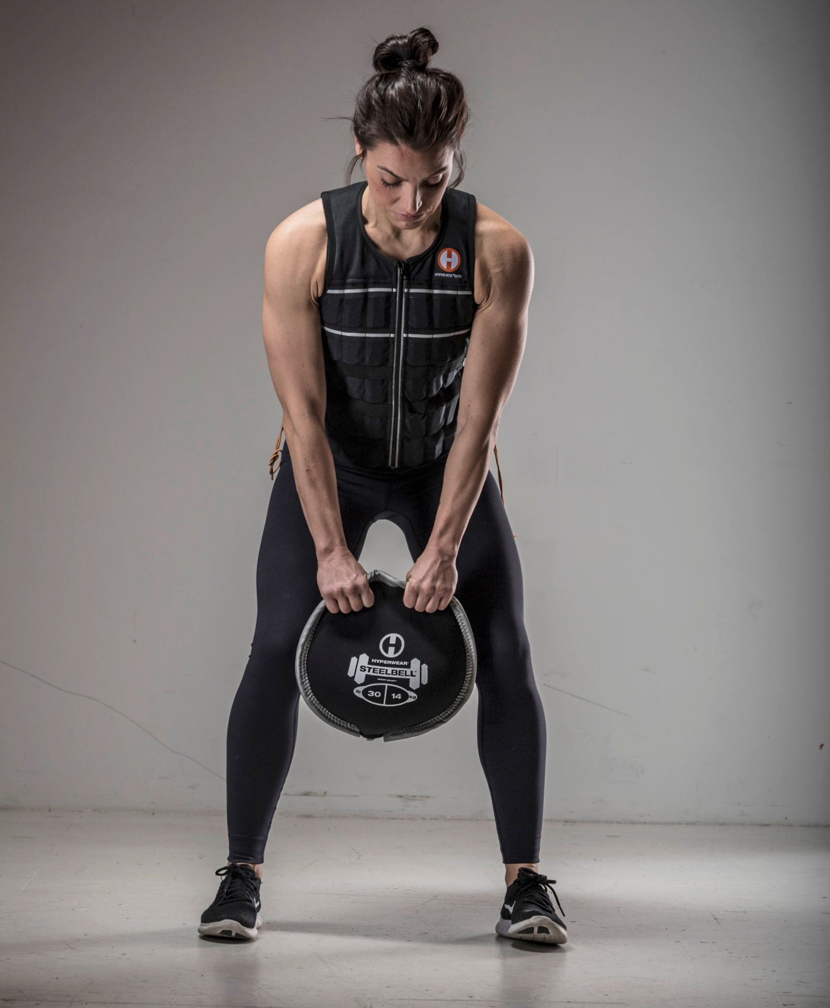 picture of female fitness model doing a kettlebell swing with a SteelBell