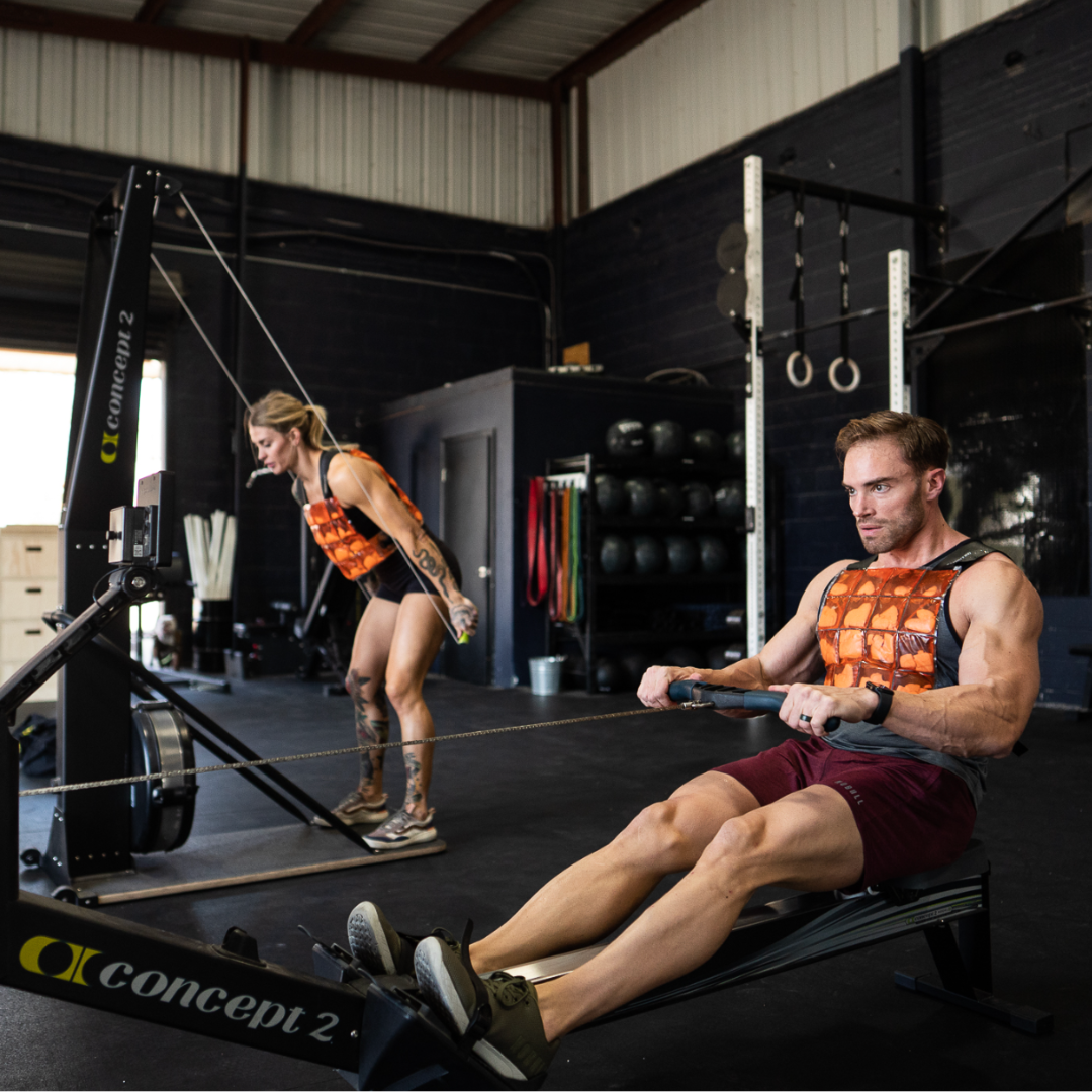 picture of hybrid athletes wearing a cooling vest using a ski erg and concept rower training for a Hyrox or CrossFit competition