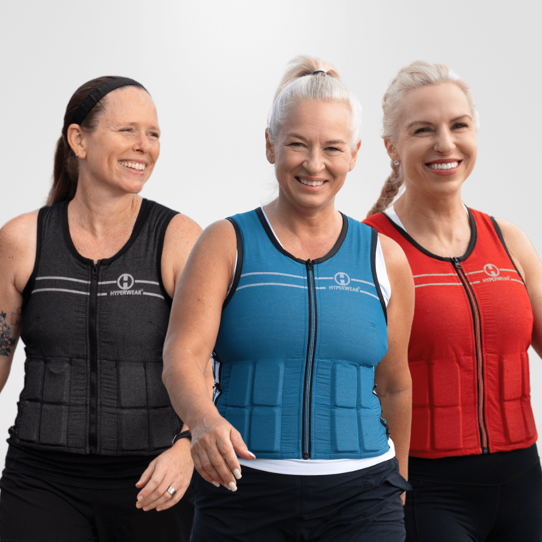 Three women wearing different colored weighted vests on a white background