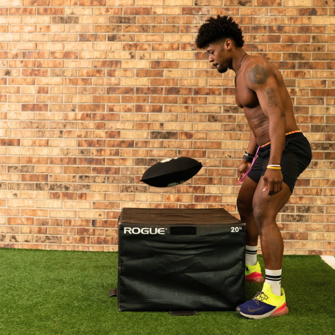 Picture of an athlete doing an overhead slam with a steelbell