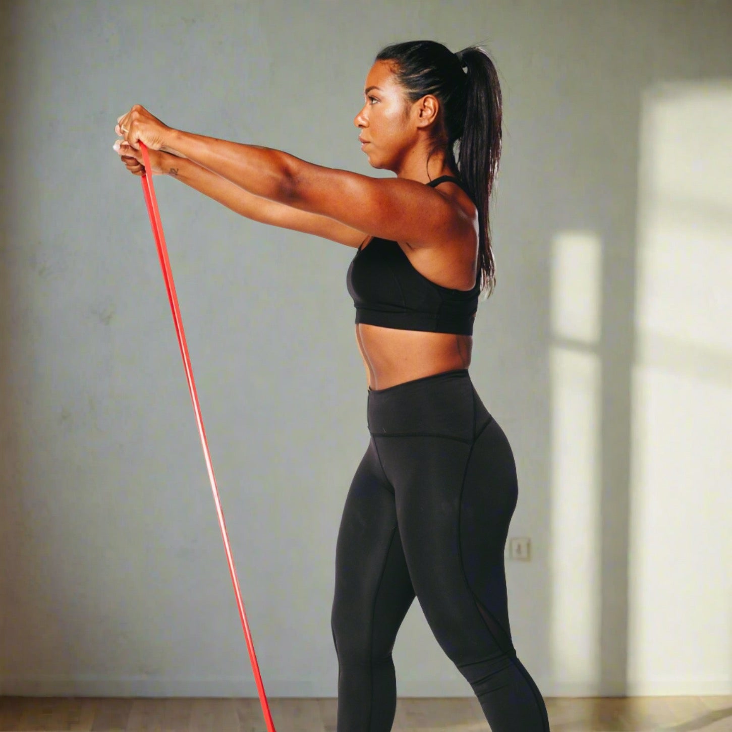Image of a woman exercising with a power resistance band