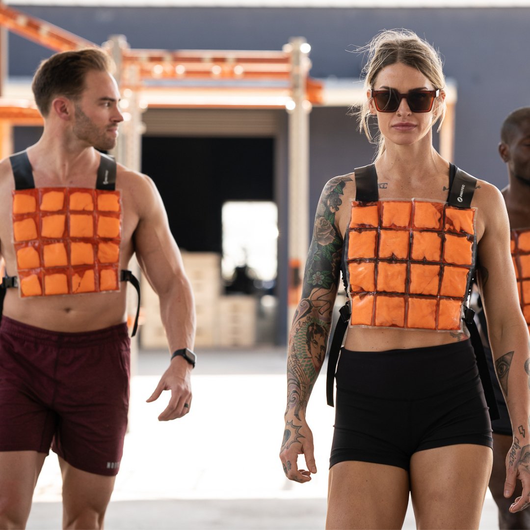 image of two fitness models wearing CoolOver cooling vests during a workout