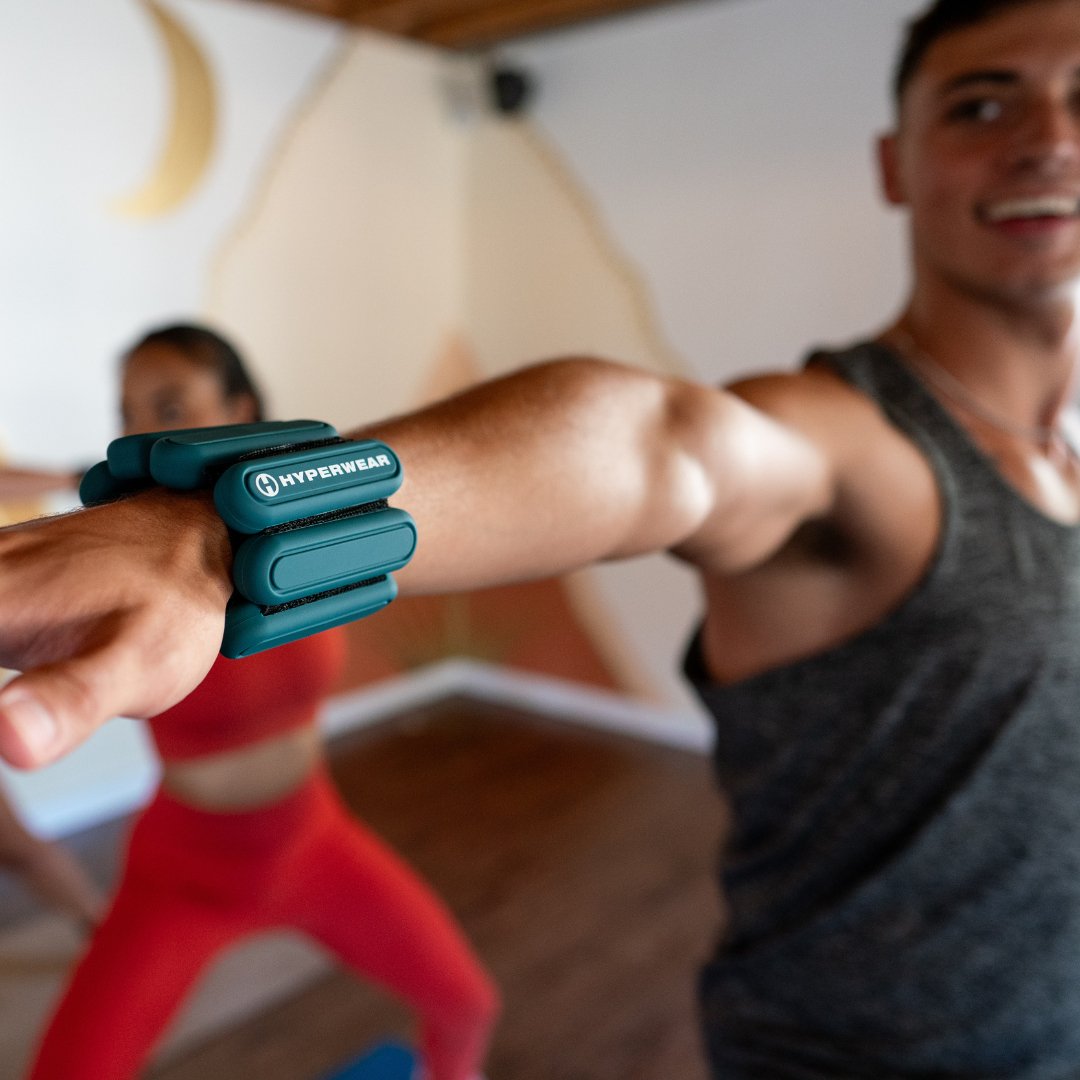 Close up image of a fitness model's wrist wearing a wrist weight