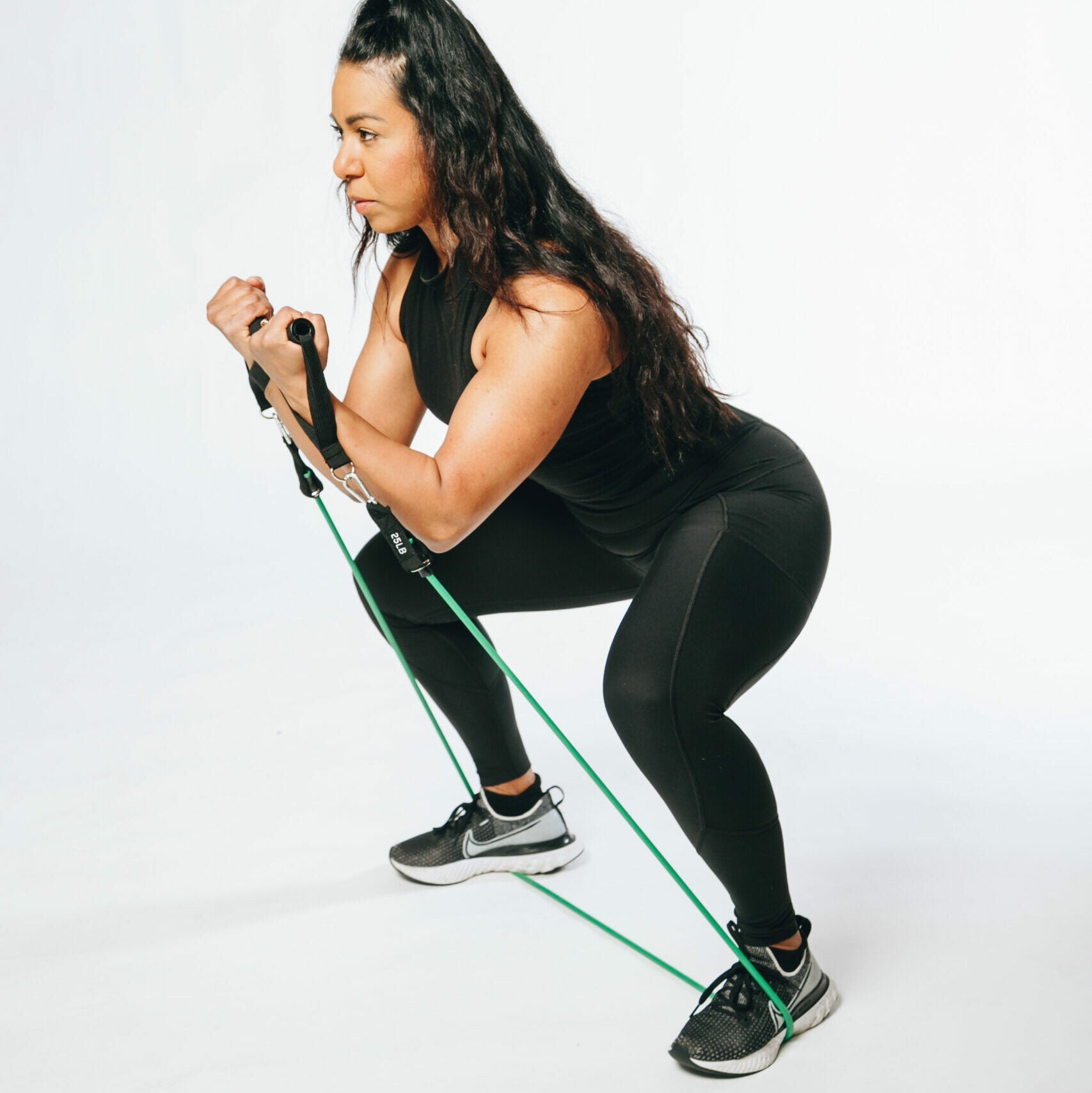 picture of a model doing a squat resistance tube exercise
