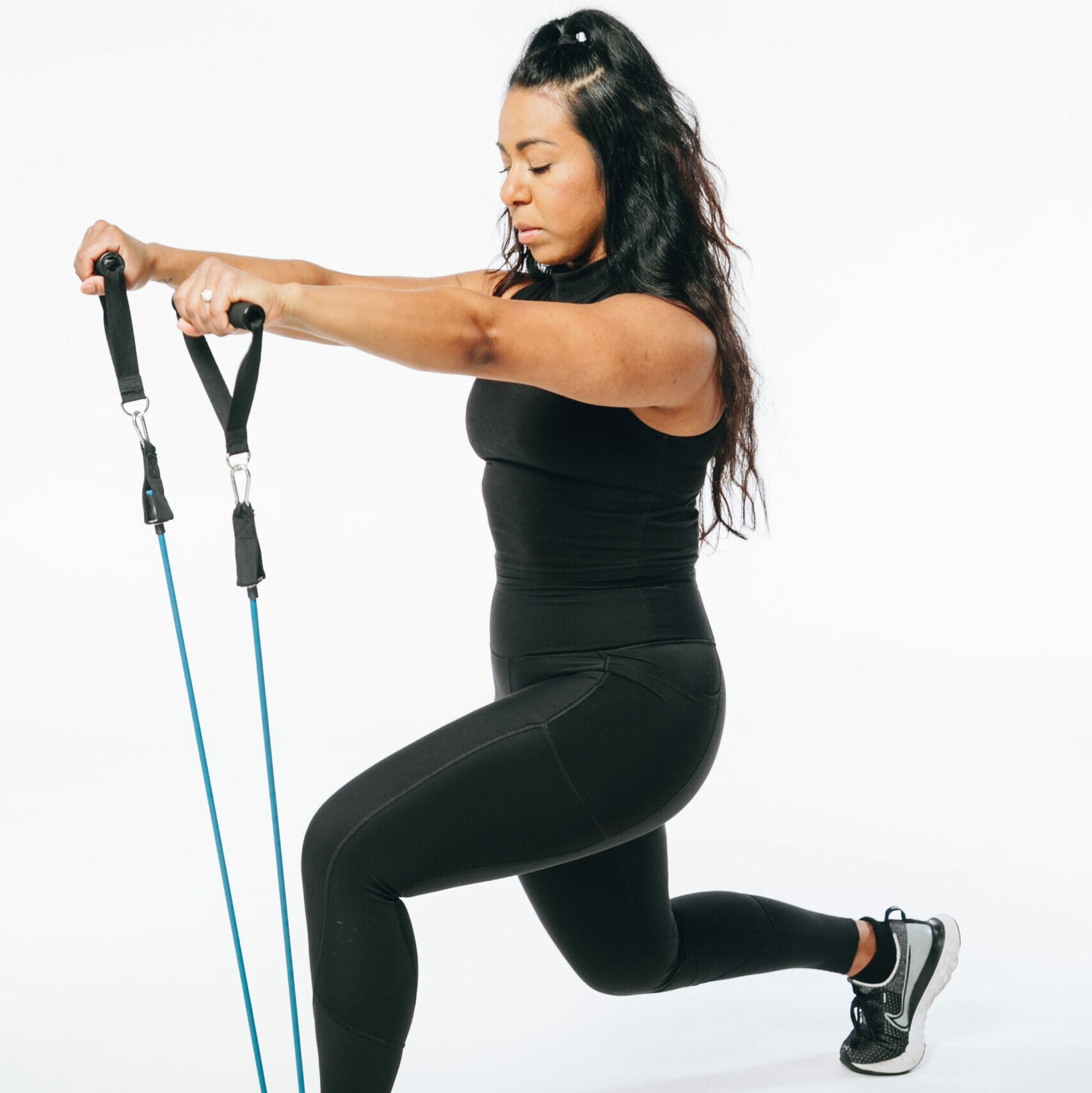 image of a model doing a lunge with resistance tube band