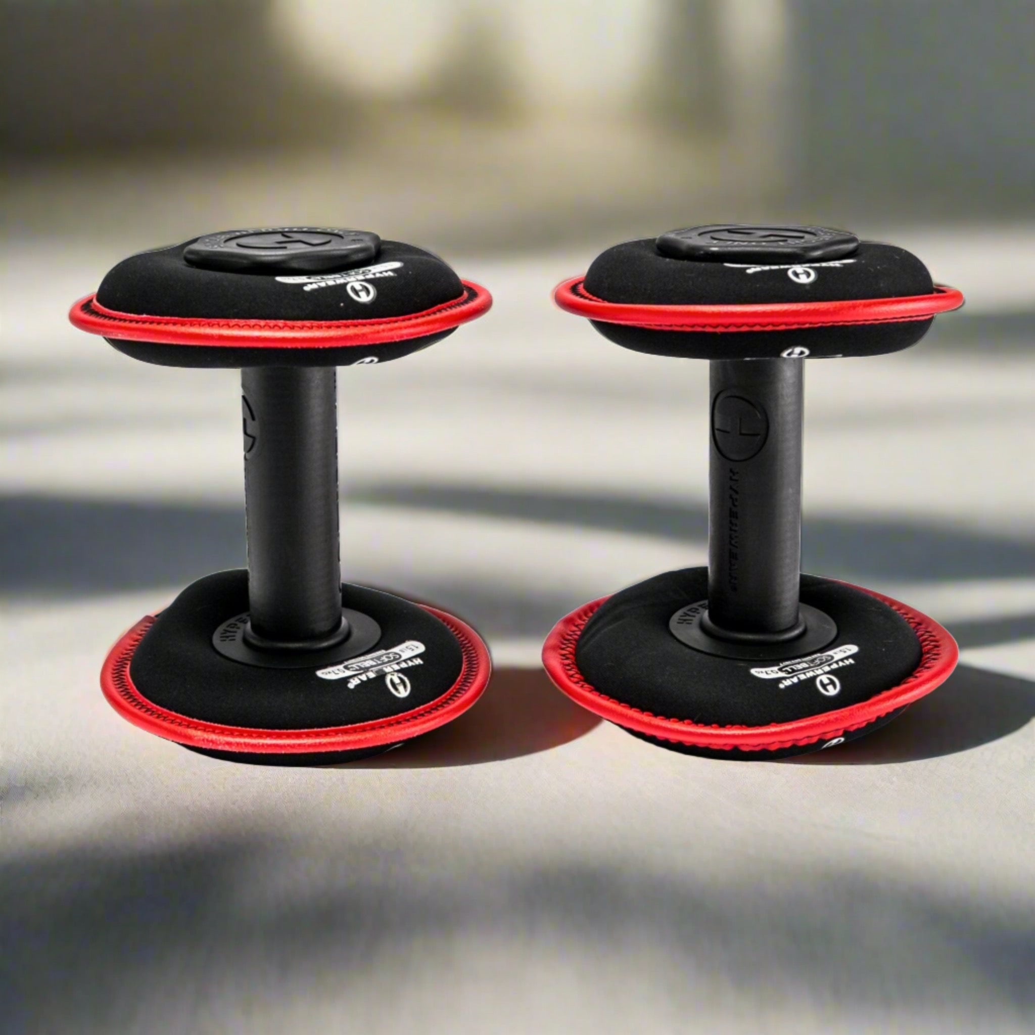 Product image of a pair of hyperwear softbell adjustable soft dumbbells standing upright