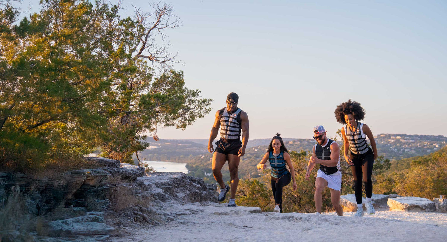image of 4 friends outdoors on a trail using a weighted vest for walking to get more benefits from walking