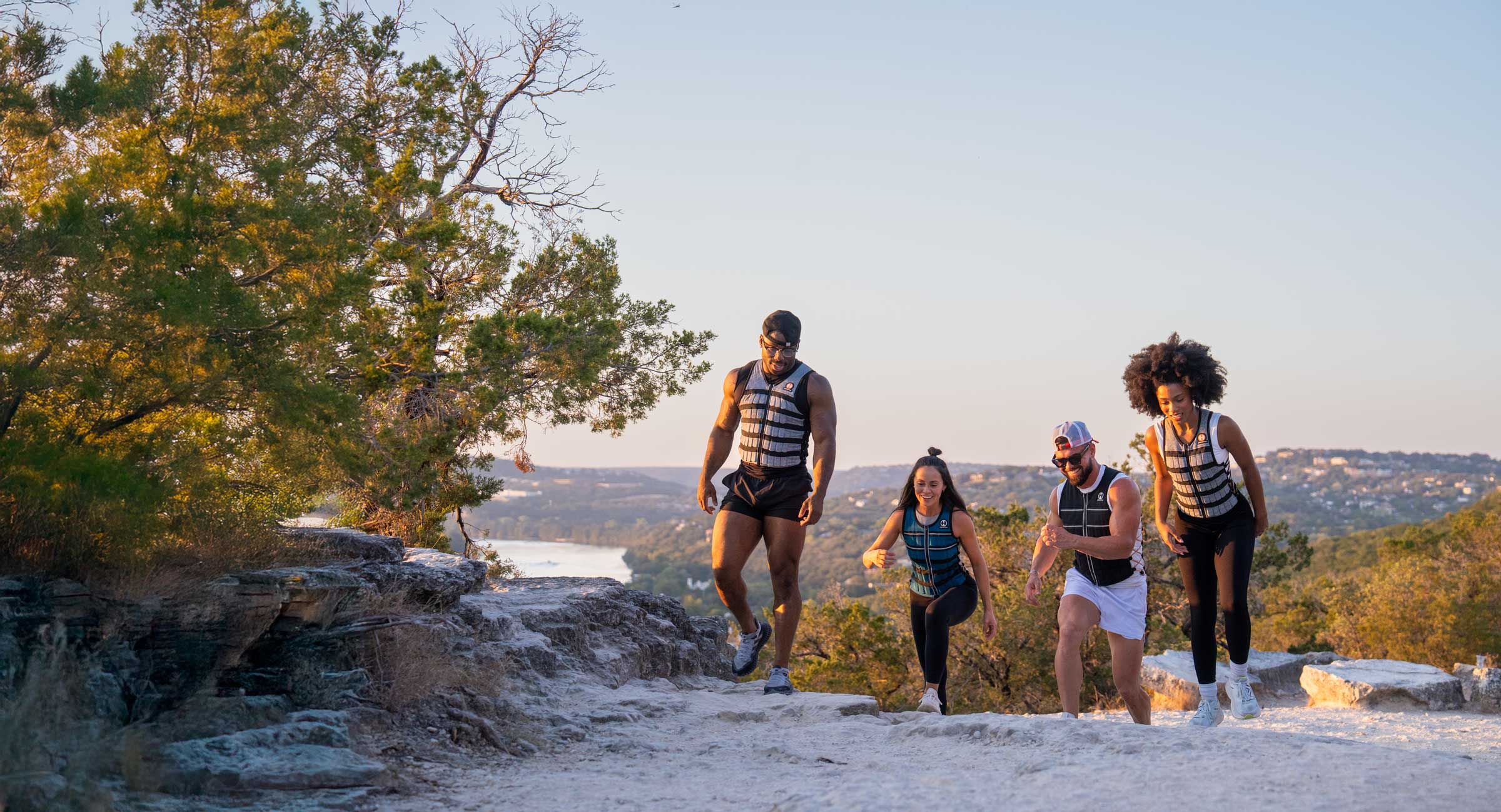 image of 4 friends outdoors on a trail using a weighted vest for walking to get more benefits from walking