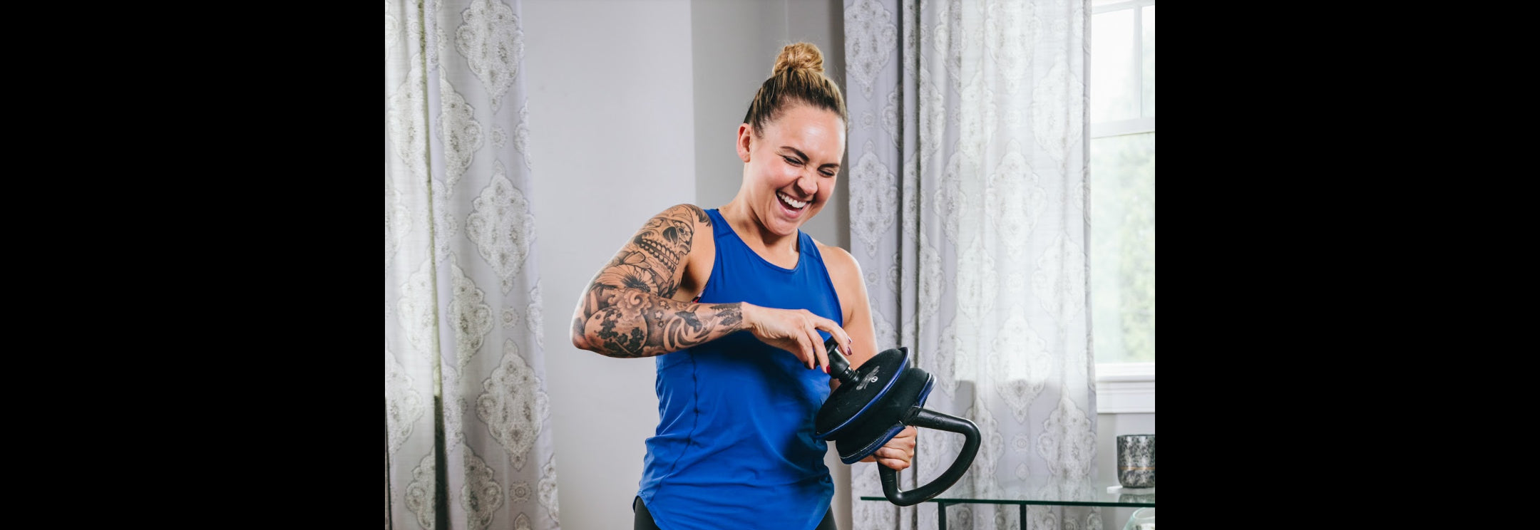 Image of a woman using her hyperwear adjustable weight soft kettlebell at home