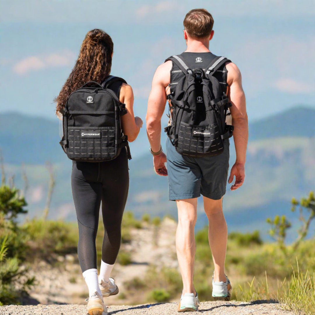 Picture of a couple rucking with rucking backpacks on a scenic mountain trail
