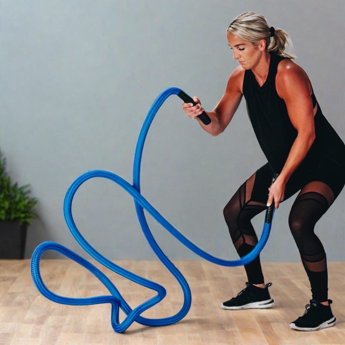 Action photo of woman doing unanchored battle rope waves in 6 feet of space