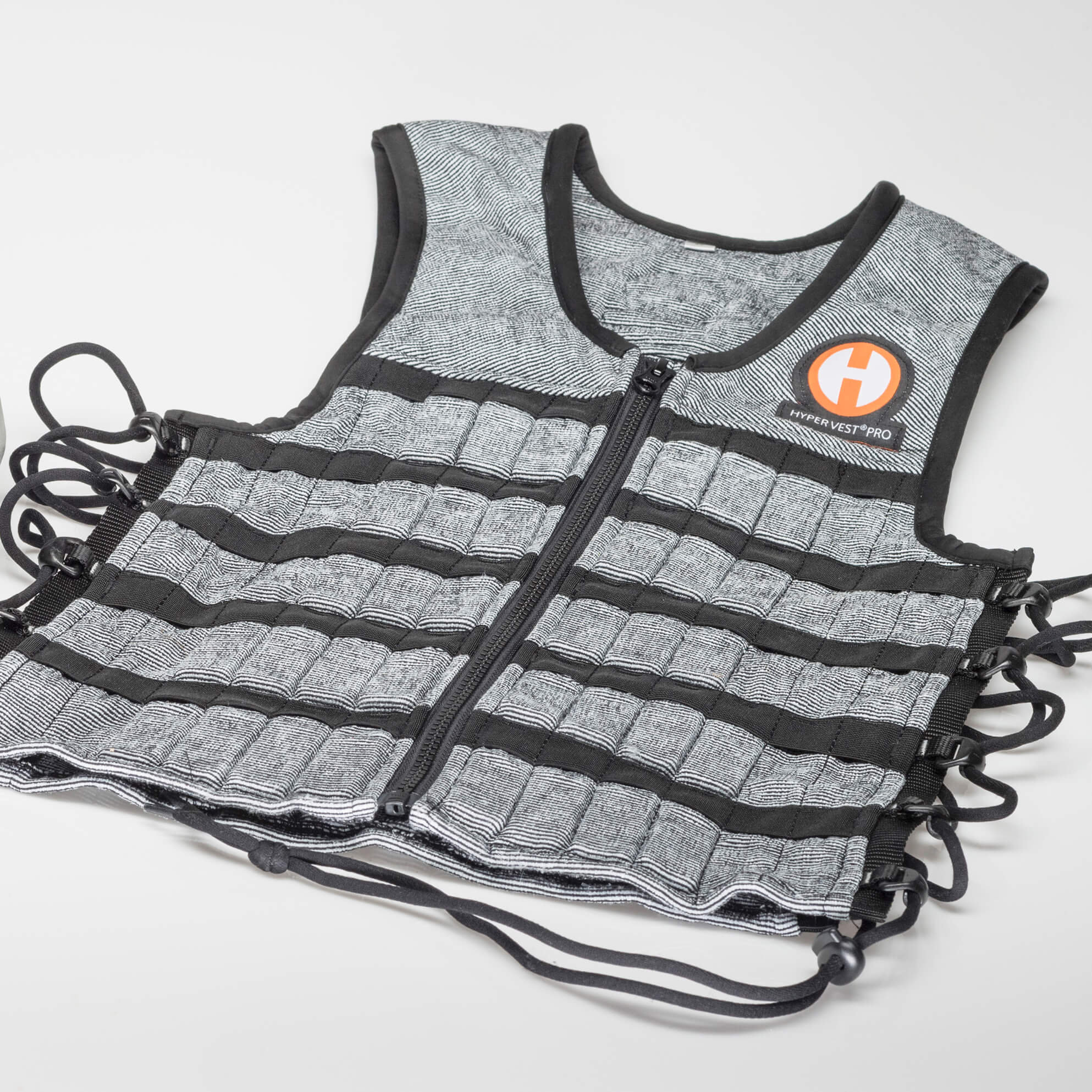 product photo of hyper vest pro lying flat zipped up and showing the side cords open
