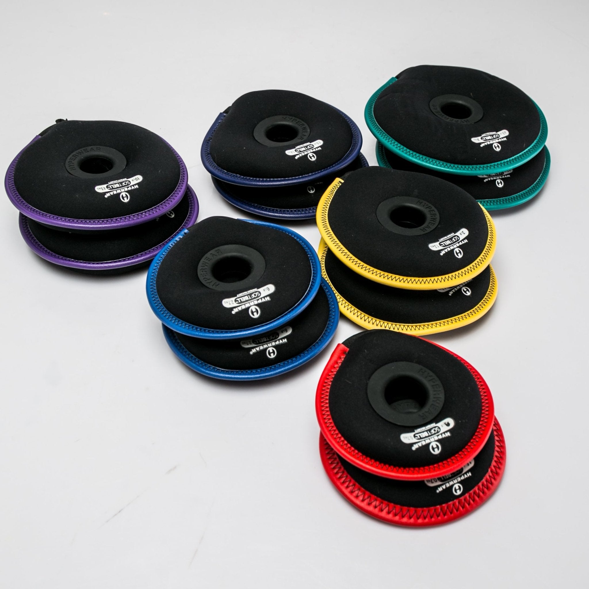 Group product image of an assortment of SoftBell hand weight plates arranged in pairs by color